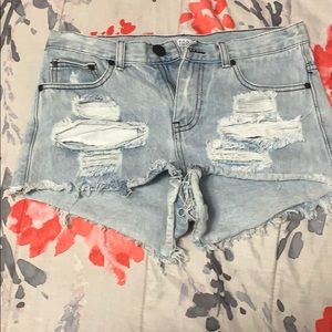 Low cut,ripped blue jean shorts